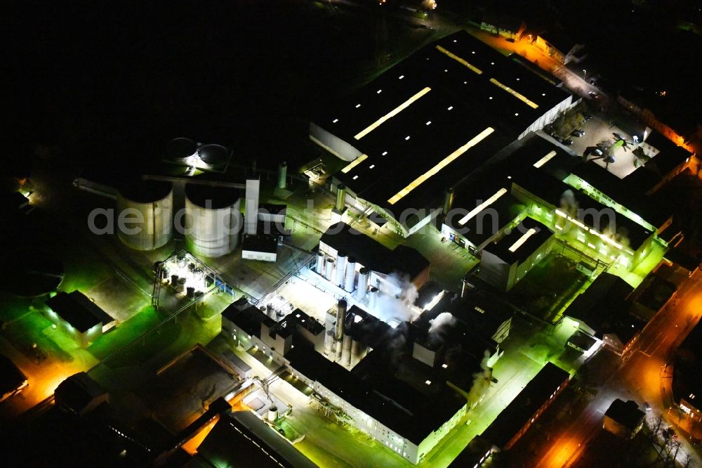 Kyritz at night from above - Night lighting building and production halls on the premises of Kyritzer Staerke GmbH in Kyritz in the state Brandenburg, Germany