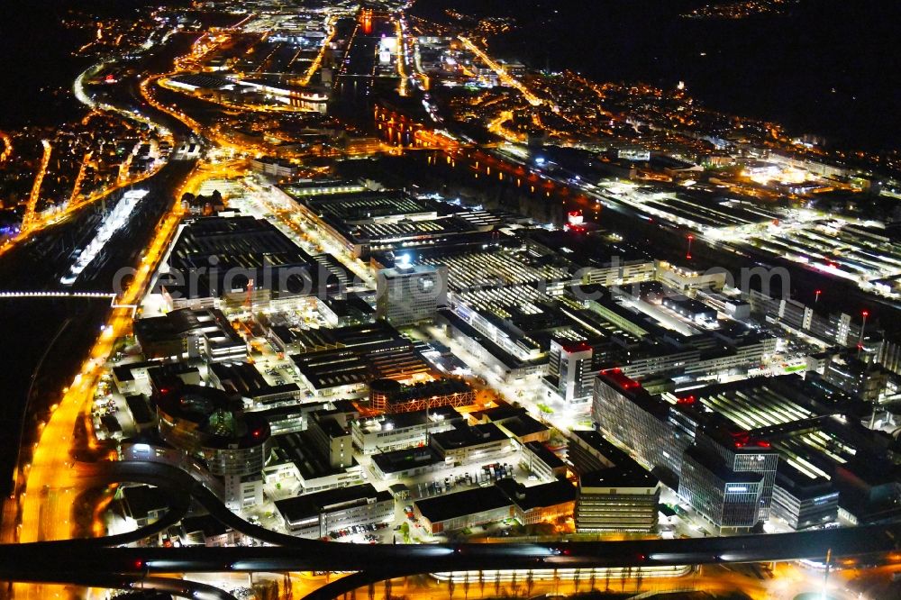 Stuttgart at night from the bird perspective: Night lighting building and production halls on the premises of Merceof-Benz Nieoflassung on Ufer of Neckar in the district Untertuerkheim in Stuttgart in the state Baden-Wurttemberg, Germany