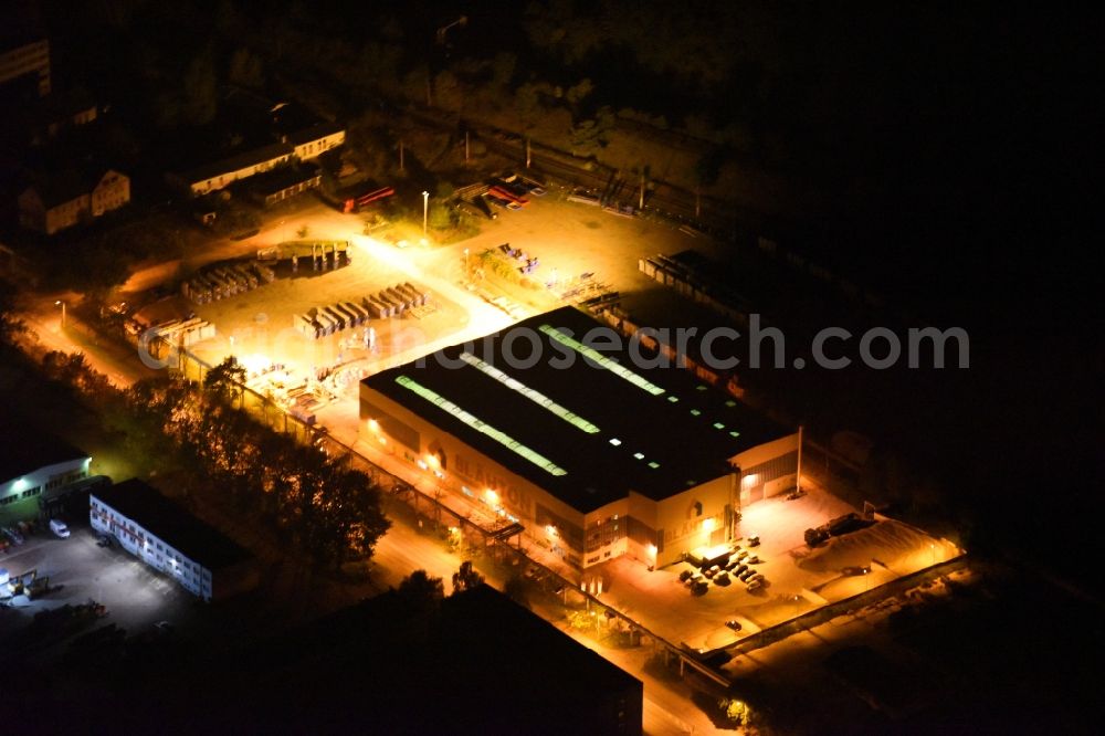 Aerial image at night Neubrandenburg - Night lighting Building and production halls on the premises of Praefa GmbH NL Blaehton Fertigteilwerk on Ihlenfelder Strasse in Neubrandenburg in the state Mecklenburg - Western Pomerania, Germany