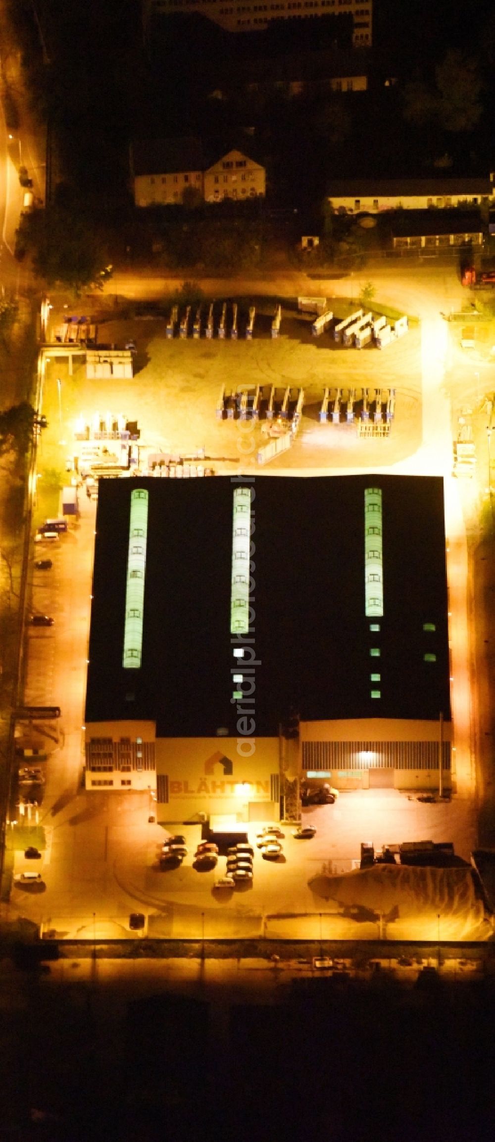 Neubrandenburg at night from above - Night lighting Building and production halls on the premises of Praefa GmbH NL Blaehton Fertigteilwerk on Ihlenfelder Strasse in Neubrandenburg in the state Mecklenburg - Western Pomerania, Germany