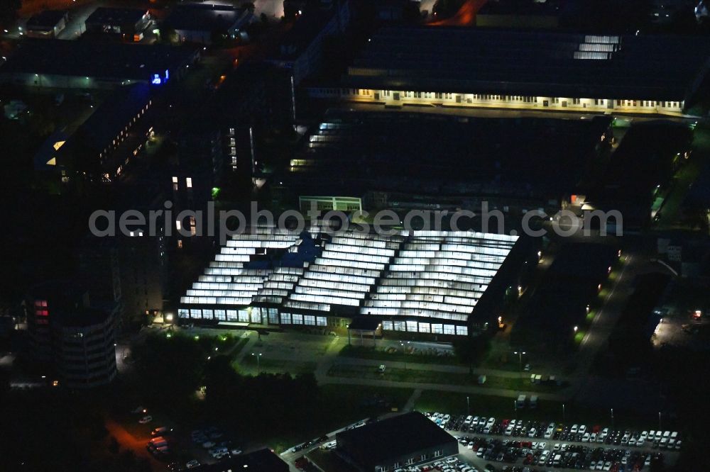 Aerial image at night Berlin - Night lighting building and production halls on the premises of Schindler Deutschland AG & Co. KG on Schindler-Platz in the district Mariendorf in Berlin, Germany