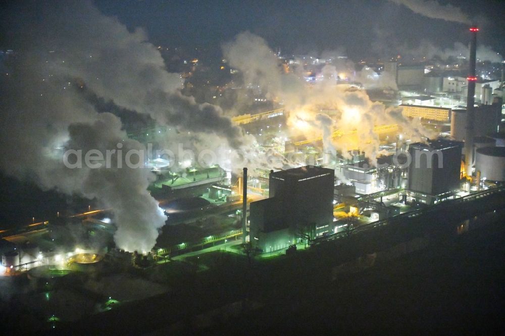 Aerial image at night Grana - Night lighting Building and production halls on the premises of Suedzucker AG on Kreisstrasse in Grana in the state Saxony-Anhalt, Germany