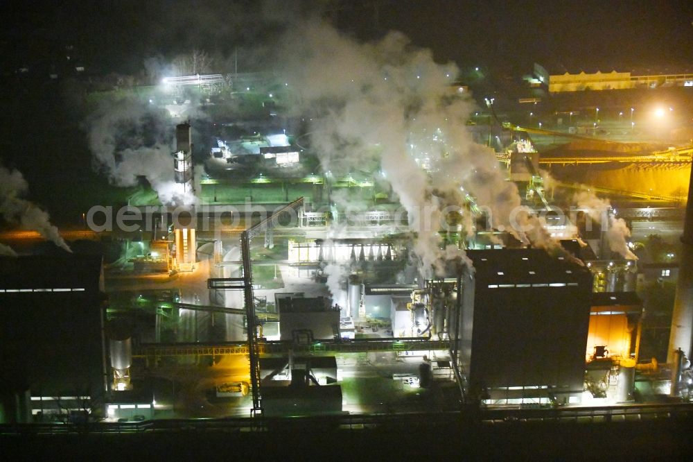 Aerial image at night Grana - Night lighting Building and production halls on the premises of Suedzucker AG on Kreisstrasse in Grana in the state Saxony-Anhalt, Germany