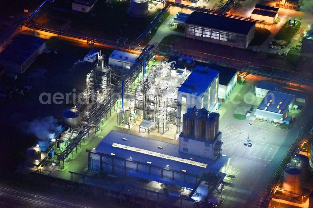 Aerial image at night Piesteritz - Night lighting refinery equipment and management systems on the factory premises of the chemical manufacturers of SKW Stickstoffwerke Piesteritz GmbH in Piesteritz in the state Saxony-Anhalt, Germany