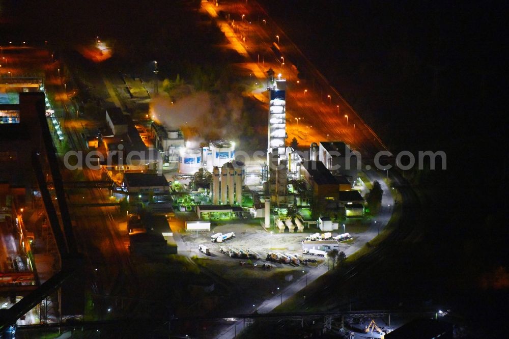 Eisenhüttenstadt at night from above - Night lighting Building and production halls on the premises of steelworks Arcelor Mittal in Eisenhuettenstadt in the state Brandenburg