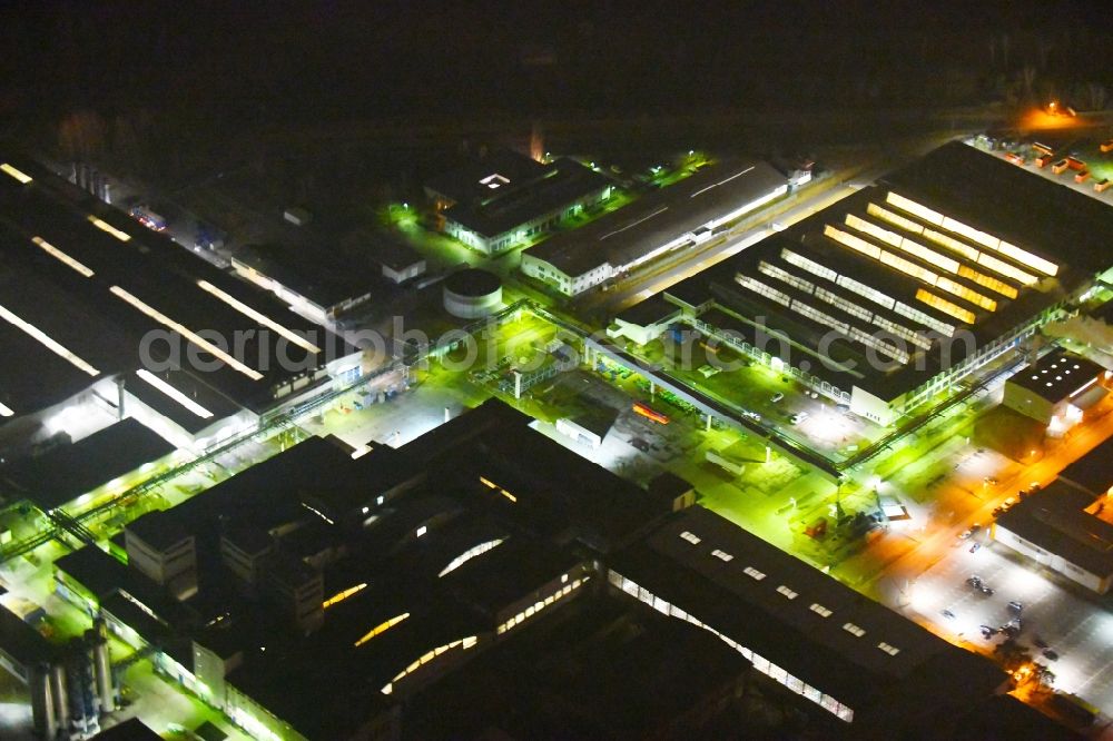 Fürstenwalde/Spree at night from above - Night lighting Building and production halls on the premises of tyre1 GmbH & Co. KG - Pneumant Am Bahndonm - Reifenwerkring in Fuerstenwalde/Spree in the state Brandenburg, Germany