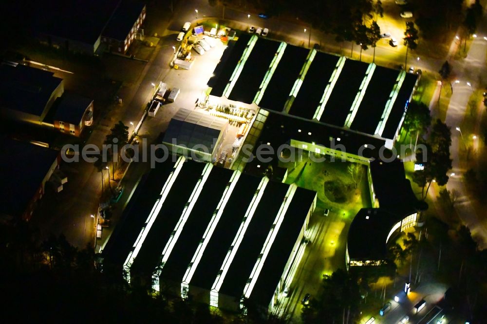 Velten at night from above - Night lighting building and production halls on the premises of Wall GmbH on Parkallee in Velten in the state Brandenburg, Germany