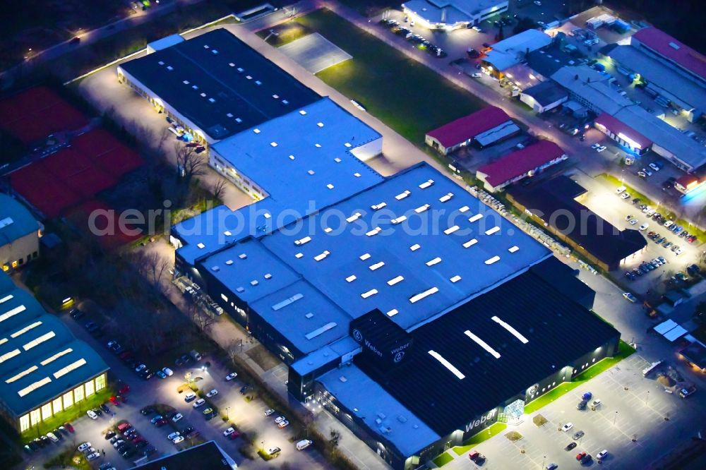 Bernau at night from above - Night lighting building and production halls on the premises of Weber Automotive GmbH in Bernau in the state Brandenburg, Germany