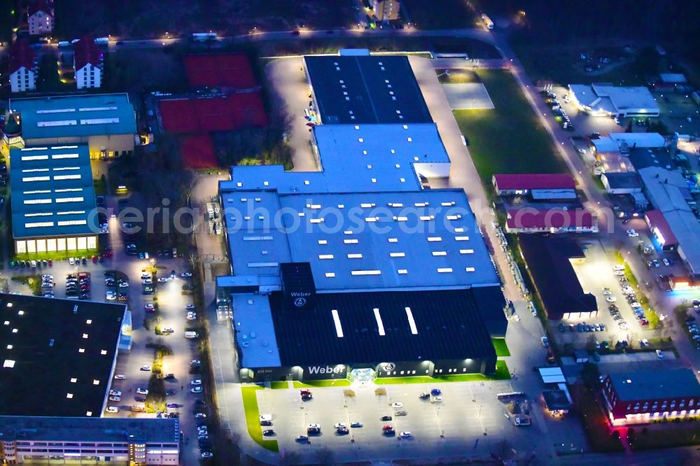 Aerial photograph at night Bernau - Night lighting building and production halls on the premises of Weber Automotive GmbH in Bernau in the state Brandenburg, Germany