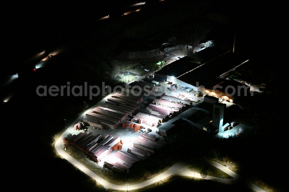 Aerial image at night Eisenberg - Night lighting building and production halls on the premises of Wienerberger GmbH in Eisenberg in the state Thuringia, Germany