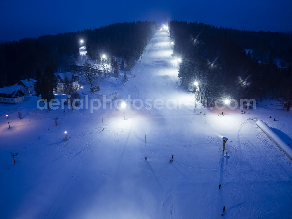 Aerial photograph at night Altenberg - Night lighting aisle and downhill slope in the winter sports ski area Snowpark on the street Am Skihang in Altenberg in the state of Saxony, Germany