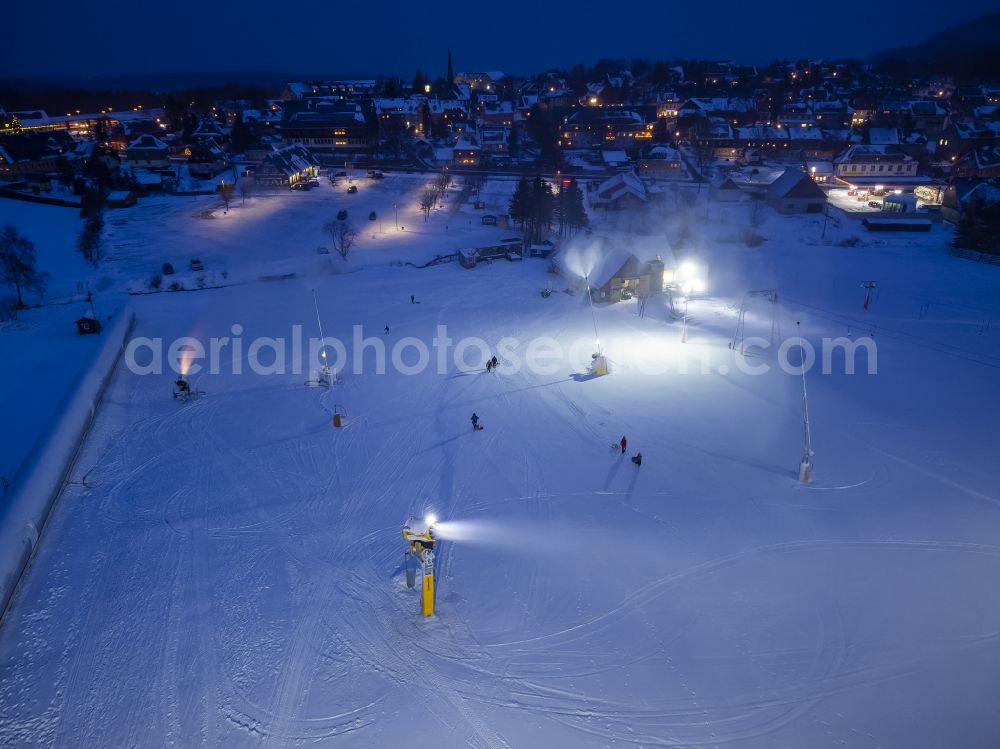 Altenberg at night from above - Night lighting aisle and downhill slope in the winter sports ski area Snowpark on the street Am Skihang in Altenberg in the state of Saxony, Germany