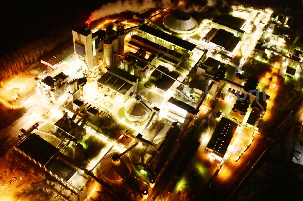 Rüdersdorf at night from the bird perspective: Night lighting cEMEX cement plant in Ruedersdorf in Brandenburg