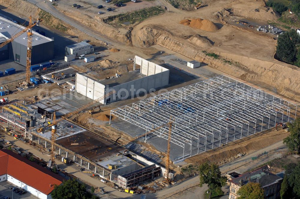 GROßRÖHRSDORF from the bird's eye view: Blick auf den Auf- und Ausbau des Werksgeändes der SUNFILM AG an der Sunfilmstraße 8 in 01900 Großröhrsdorf (+49 35952 280-0, info@sunfilm.com). An diesem Standort laufen Bauarbeiten für die größte Produktionsstätte Sachsens zur Herstellung von Dünnschicht-Fotovoltaik-Modulen.