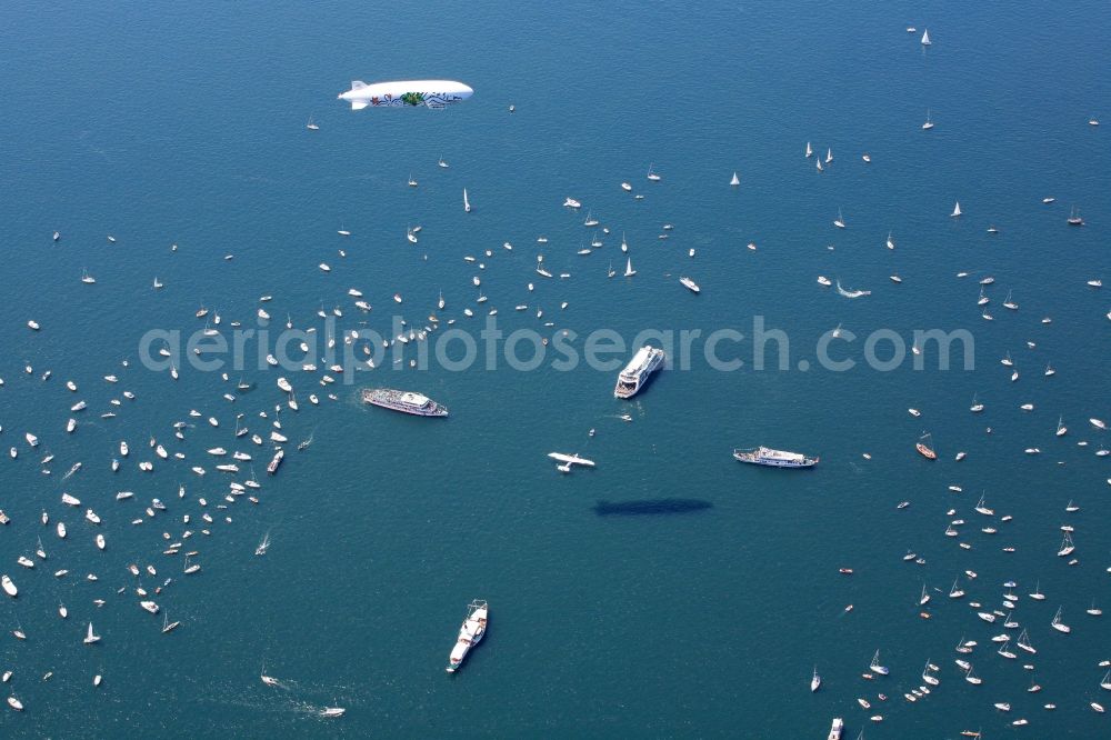 Aerial image Friedrichshafen - Between Romanshorn in Switzerland and Friedrichshafen in Germany 2500 ships form a bridge of boats to commemorate the help of the Swiss people for the German post-war children 60 years ago. In the middle of the lake, a large Swiss cross was formed by large vessels. In the middle of the cross the historic flying boat Do 24