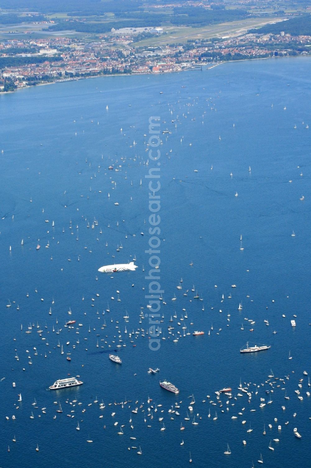 Friedrichshafen from the bird's eye view: Between Romanshorn in Switzerland and Friedrichshafen in Germany 2500 ships form a bridge of boats to commemorate the help of the Swiss people for the German post-war children 60 years ago. In the middle of the lake, a large Swiss cross was formed by large vessels. In the middle of the cross the historic flying boat Do 24