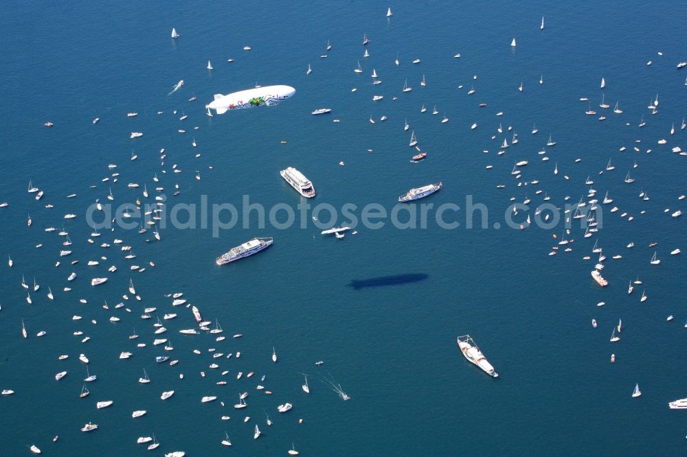 Aerial image Friedrichshafen - Between Romanshorn in Switzerland and Friedrichshafen in Germany 2500 ships form a bridge of boats to commemorate the help of the Swiss people for the German post-war children 60 years ago. In the middle of the lake, a large Swiss cross was formed by large vessels. In the middle of the cross the historic flying boat Do 24