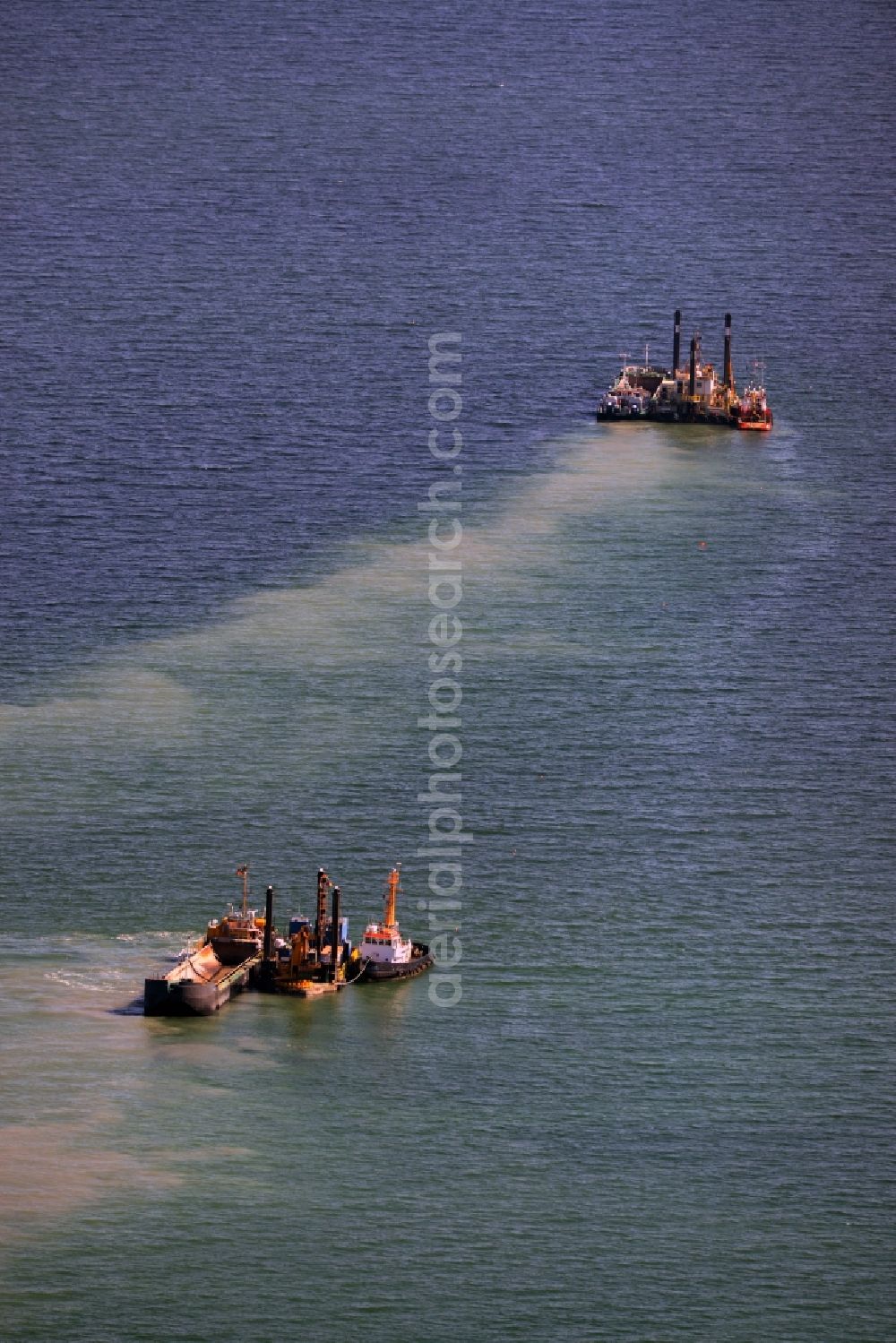 Aerial photograph Warnemünde - Dredging work on a route - fairway on the water surface of baltic sea in Warnemuende in the state Mecklenburg - Western Pomerania