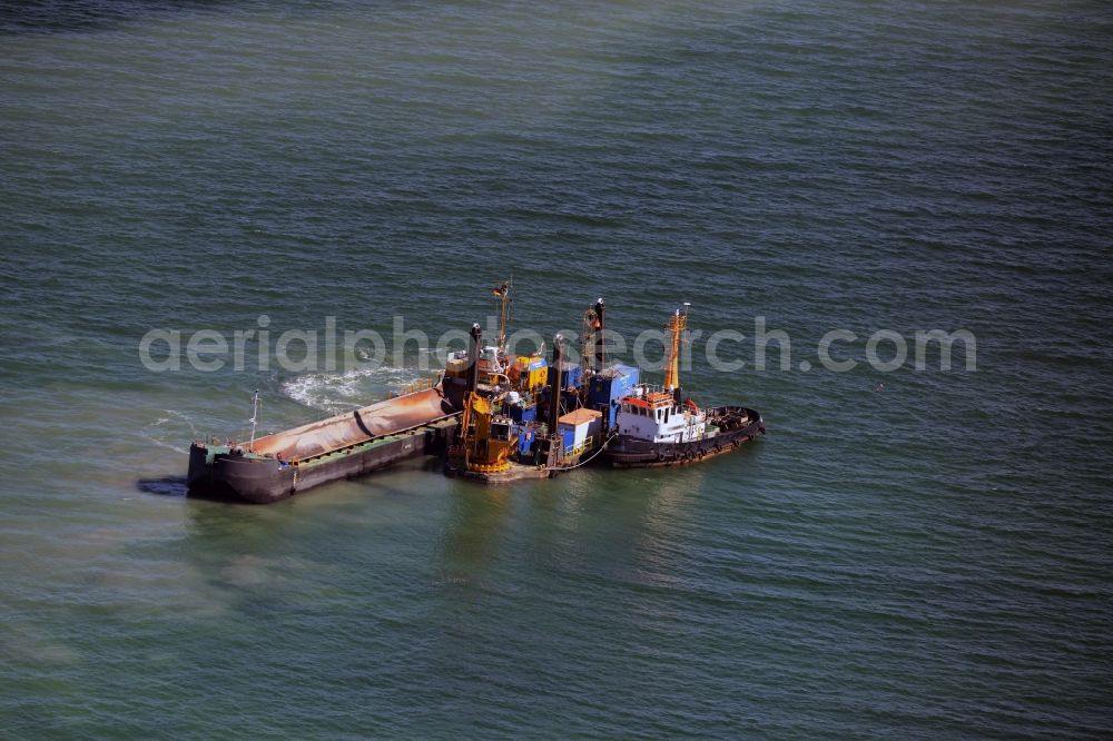 Warnemünde from the bird's eye view: Dredging work on a route - fairway on the water surface of baltic sea in Warnemuende in the state Mecklenburg - Western Pomerania