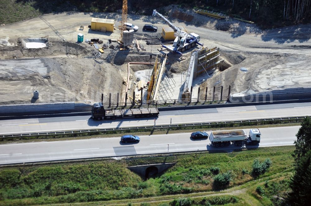 Dittersdorf from the bird's eye view: Buildings and route of the motorway A9 motorway with four lanes now. Currently, reconstruction, expansion and new construction work is underway for the six-lane expansion of Highway 9 between Triptis and Schleiz by Wayss & Freytag Ingenieurbau and EUROVIA VINCI