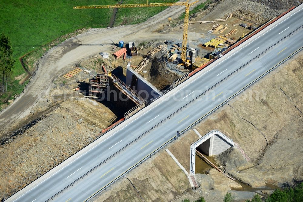 Dittersdorf from the bird's eye view: Buildings and route of the motorway A9 motorway with four lanes now. Currently, reconstruction, expansion and new construction work is underway for the six-lane expansion of Highway 9 between Triptis and Schleiz by Wayss & Freytag Ingenieurbau and EUROVIA VINCI