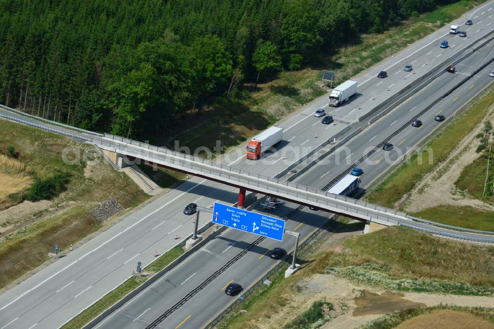 Dittersdorf from the bird's eye view: Buildings and route of the motorway A9 motorway with four lanes now. Currently, reconstruction, expansion and new construction work is underway for the six-lane expansion of Highway 9 between Triptis and Schleiz by Wayss & Freytag Ingenieurbau and EUROVIA VINCI