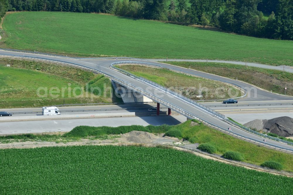 Mönchgrün from the bird's eye view: Buildings and route of the motorway A9 motorway with four lanes now. Currently, reconstruction, expansion and new construction work is underway for the six-lane expansion of Highway 9near Moenchgruen by Wayss & Freytag Ingenieurbau and EUROVIA VINCI in Thuringia