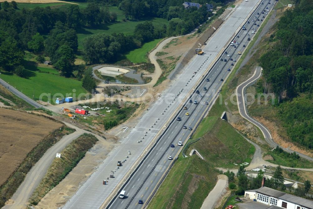 Mönchgrün from the bird's eye view: Buildings and route of the motorway A9 motorway with four lanes now. Currently, reconstruction, expansion and new construction work is underway for the six-lane expansion of Highway 9near Moenchgruen by Wayss & Freytag Ingenieurbau and EUROVIA VINCI in Thuringia