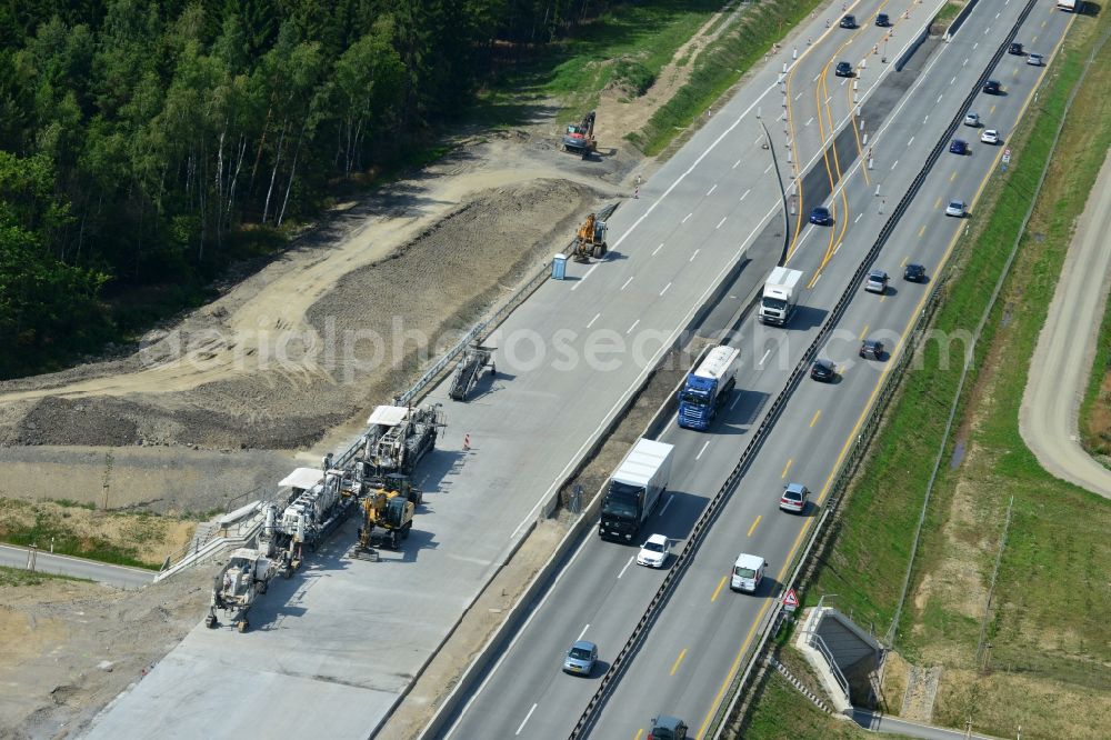 Pörmitz from the bird's eye view: Buildings and route of the motorway A9 motorway with four lanes now. Currently, reconstruction, expansion and new construction work is underway for the six-lane expansion of Highway 9 near Poermitz by Wayss & Freytag Ingenieurbau and EUROVIA VINCI in Thuringia