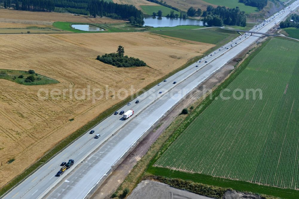 Pörmitz from above - Buildings and route of the motorway A9 motorway with four lanes now. Currently, reconstruction, expansion and new construction work is underway for the six-lane expansion of Highway 9 near Poermitz by Wayss & Freytag Ingenieurbau and EUROVIA VINCI in Thuringia