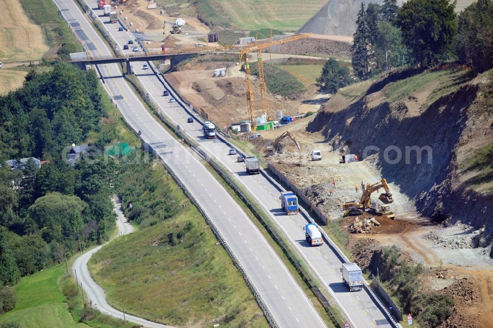 Schleiz from the bird's eye view: Buildings and route of the motorway A9 motorway with four lanes now. Currently, reconstruction, expansion and new construction work is underway for the six-lane expansion of Highway 9 between Triptis and Schleiz by Wayss & Freytag Ingenieurbau and EUROVIA VINCI in Thuringia