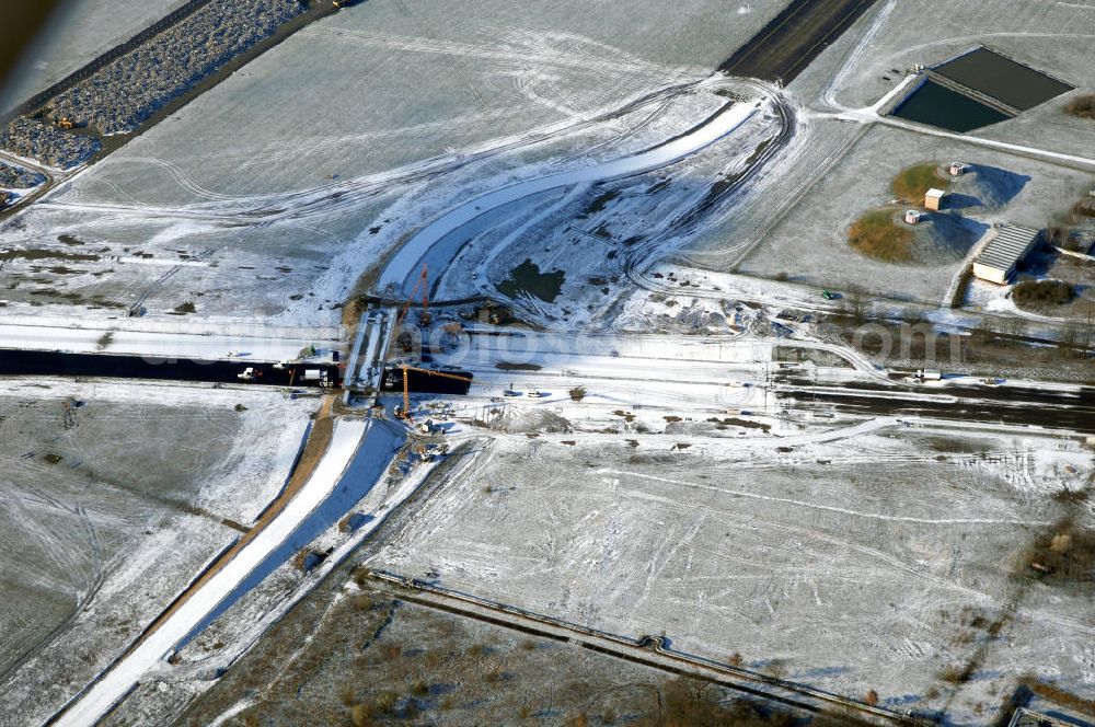 Schönefeld from the bird's eye view: Blick auf den Ausbau der A113n als südöstliches Tor zur Hauptstadt. Unter Berücksichtigung des Flughafens Berlin Brandenburg International wurde eine Verkehrskonzeption für den Ausbau des Straßennetzes im Raum Berlin-Schönefeld erarbeitet, die zwei Stufen umfasste. Die erste Stufe sah den vierstreifigen Ausbau der Bundesstraßen B 96a und B 179 mit der Anbindung des Flughafens über zwei Knotenpunkte vor. Inhalt der zweiten Stufe war der Anschluß der Bundesautobahn A 113 neu an die B 96a und B 179. SCHÜßLER Plan Ingenieurgesellschaft, BATEG, EUROVIA