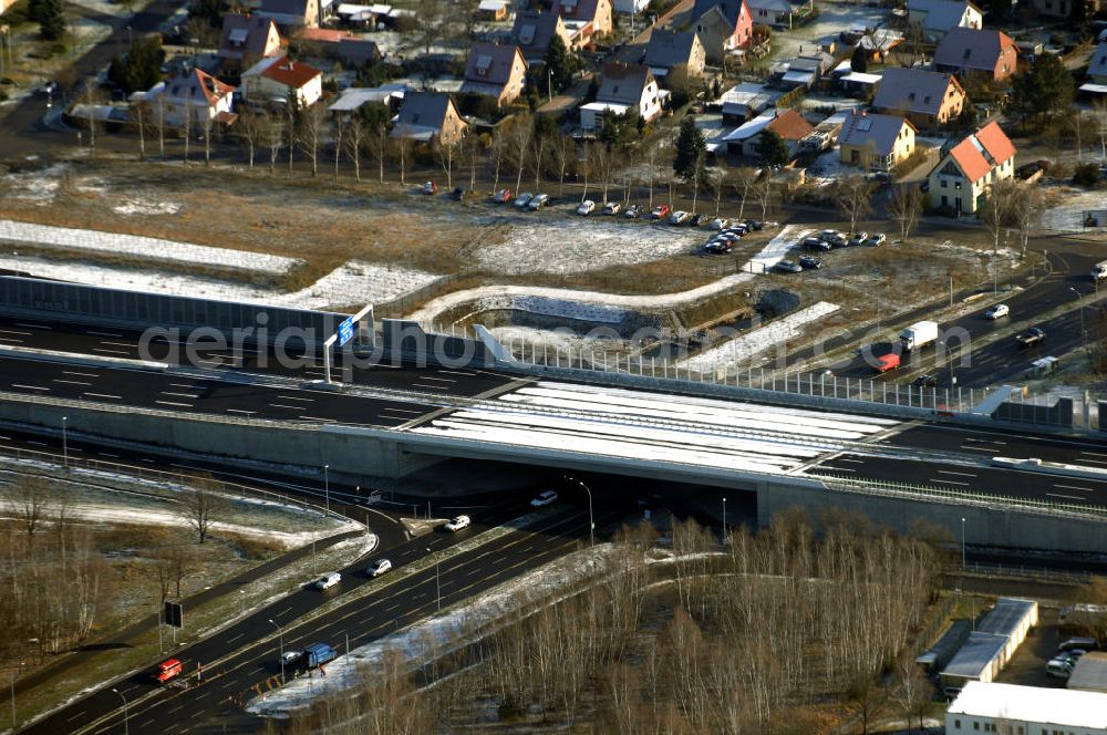 Aerial photograph Schönefeld - Blick auf den Ausbau der A113n als südöstliches Tor zur Hauptstadt. Unter Berücksichtigung des Flughafens Berlin Brandenburg International wurde eine Verkehrskonzeption für den Ausbau des Straßennetzes im Raum Berlin-Schönefeld erarbeitet, die zwei Stufen umfasste. Die erste Stufe sah den vierstreifigen Ausbau der Bundesstraßen B 96a und B 179 mit der Anbindung des Flughafens über zwei Knotenpunkte vor. Inhalt der zweiten Stufe war der Anschluß der Bundesautobahn A 113 neu an die B 96a und B 179. SCHÜßLER Plan Ingenieurgesellschaft, BATEG, EUROVIA