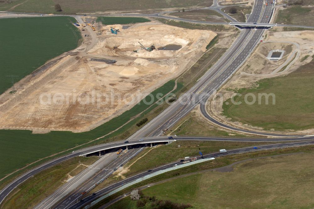 Schönefeld from the bird's eye view: Blick auf den Bereich der Stadtautobahn / Zubringer A113n als südöstliches Tor zur Hauptstadt kurz vor der Verkehrsfreigabe. Unter Berücksichtigung des Flughafens Berlin Brandenburg International wurde eine Verkehrskonzeption für den Ausbau des Straßennetzes im Raum Berlin-Schönefeld erarbeitet, die zwei Stufen umfasste. Die erste Stufe sah den vierstreifigen Ausbau der Bundesstraßen B 96a und B 179 mit der Anbindung des Flughafens über zwei Knotenpunkte vor. Inhalt der zweiten Stufe war der Anschluß der Bundesautobahn A 113 neu an die B 96a und B 179. SCHÜßLER Plan Ingenieurgesellschaft, BATEG, EUROVIA, BERGER