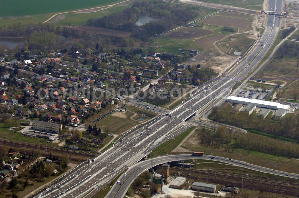 Schönefeld from the bird's eye view: Blick auf den Bereich der Stadtautobahn / Zubringer A113n als südöstliches Tor zur Hauptstadt kurz vor der Verkehrsfreigabe. Unter Berücksichtigung des Flughafens Berlin Brandenburg International wurde eine Verkehrskonzeption für den Ausbau des Straßennetzes im Raum Berlin-Schönefeld erarbeitet, die zwei Stufen umfasste. Die erste Stufe sah den vierstreifigen Ausbau der Bundesstraßen B 96a und B 179 mit der Anbindung des Flughafens über zwei Knotenpunkte vor. Inhalt der zweiten Stufe war der Anschluß der Bundesautobahn A 113 neu an die B 96a und B 179. SCHÜßLER Plan Ingenieurgesellschaft, BATEG, EUROVIA, BERGER