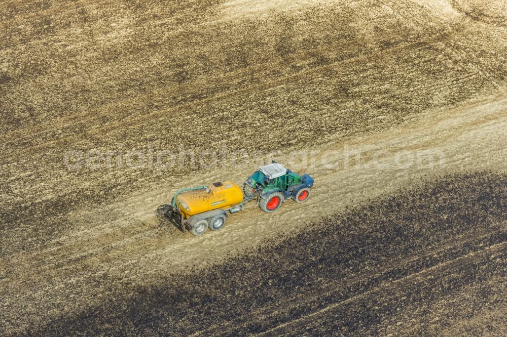 Enkdorf from above - Spraying manure as fertilizer with tractor and tank trailer on agricultural fields in Enkdorf in the state North Rhine-Westphalia, Germany