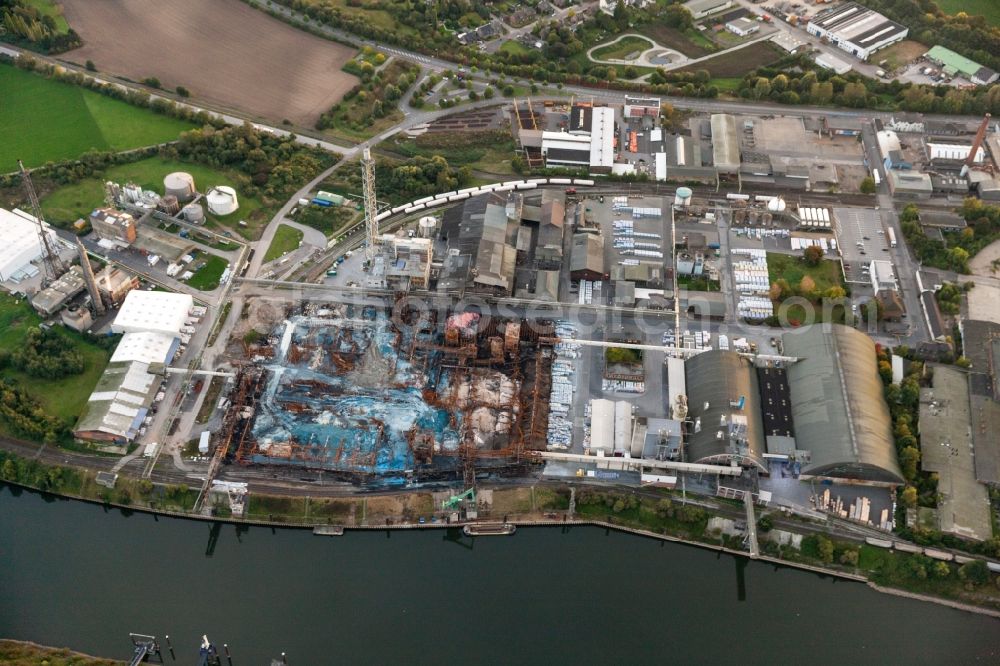 Krefeld from above - View at a burned-out storage hall on the site of the fertilizer producer COMPO GmbH & Co.KG in the Rhine harbor in the district Uerdingen in Krefeld in the federal state North Rhine-Westphalia. During the fire, according to the company Compo, about 33 thousand tons of chemicals are burned. Operator of the port is the port Krefeld GmbH & Co. KG