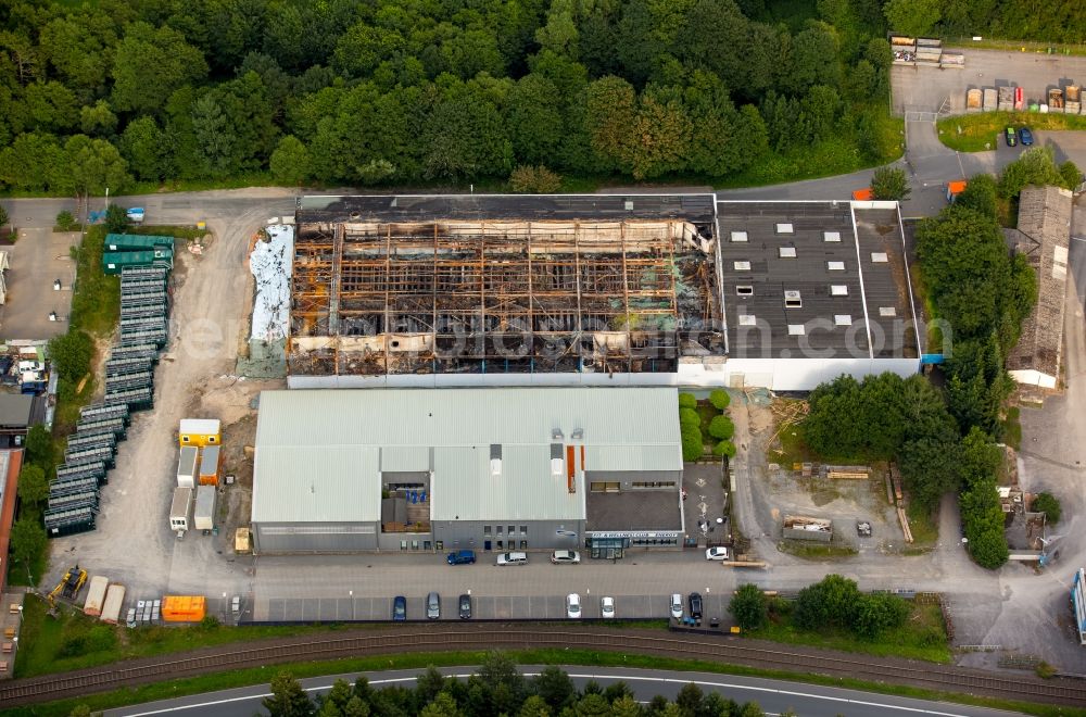 Aerial photograph Warstein - Burnt down building of the Al Gramm company in the commerce area of Waersteral in Warstein in the state of North Rhine-Westphalia. The burnt building is located near a forest