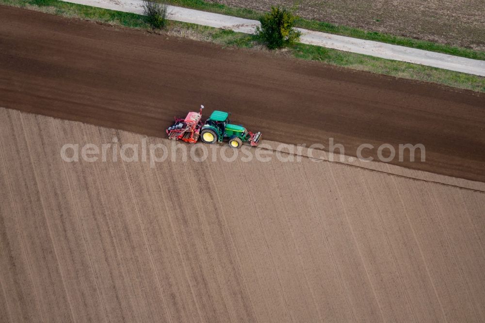 Aerial photograph Rosdorf - Sowing by a tractor on agricultural fields in Rosdorf in the state Lower Saxony, Germany