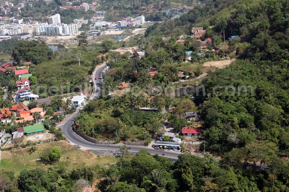 Patong from the bird's eye view: Outskirts of the city of Patong on Phuket Island in Thailand with traditional houses with palm trees