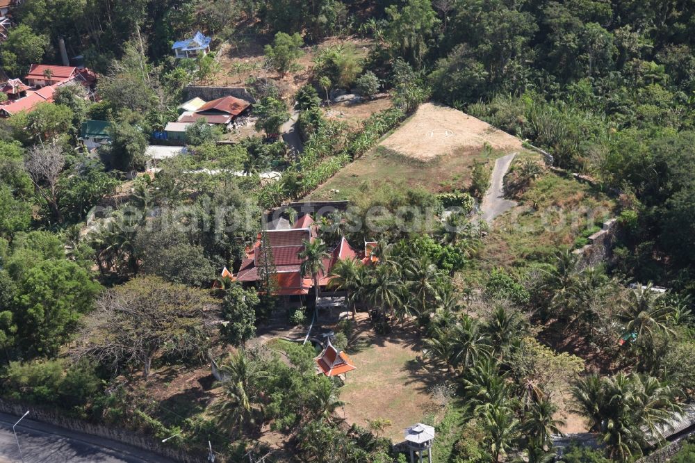 Patong from above - Outskirts of the city of Patong on Phuket Island in Thailand with traditional houses with palm trees