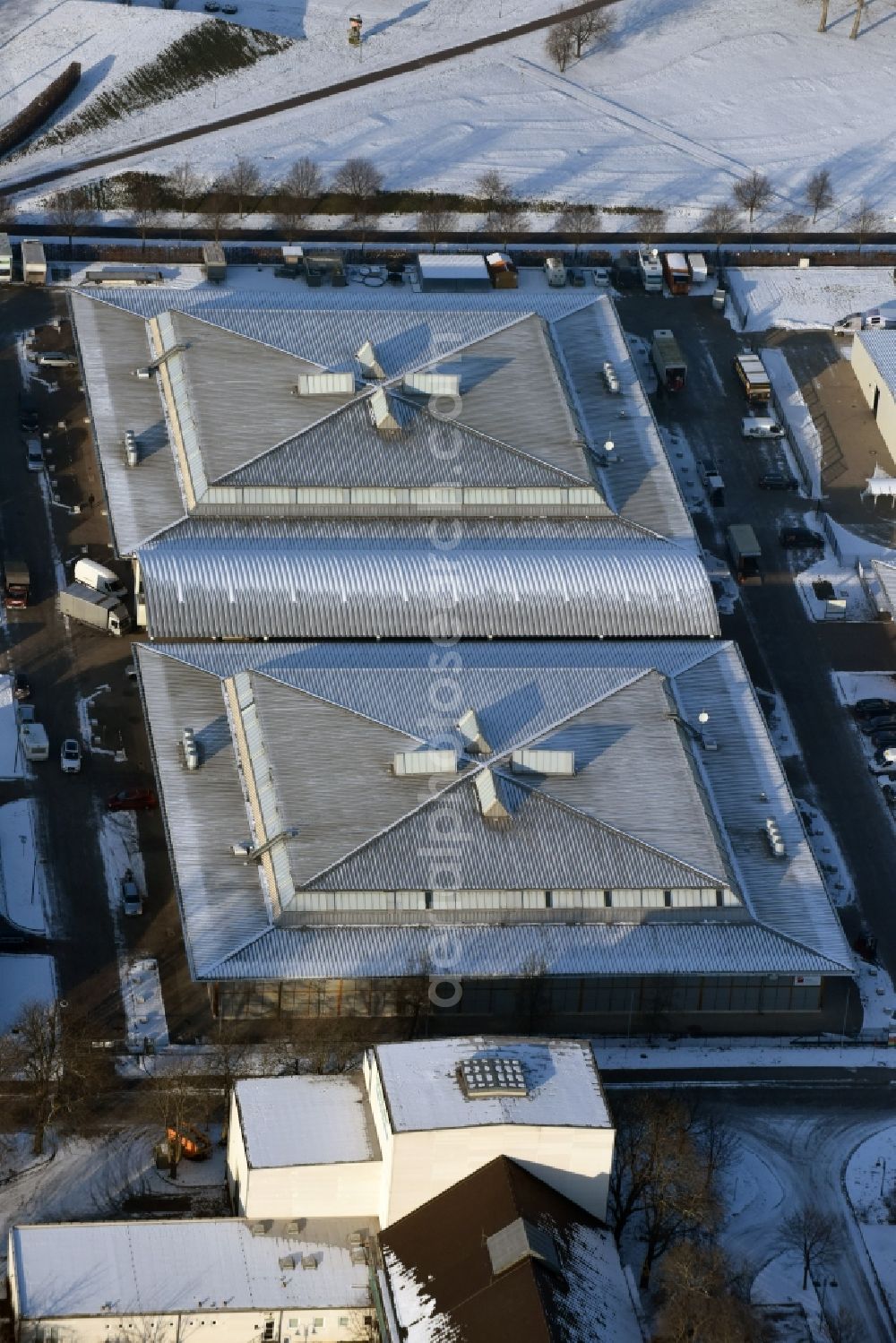 Aerial photograph Magdeburg - Winterly snowy exhibition grounds and exhibition halls of the Messe Magdeburg besides the road Tessenowstrasse in Magdeburg in the state Saxony-Anhalt