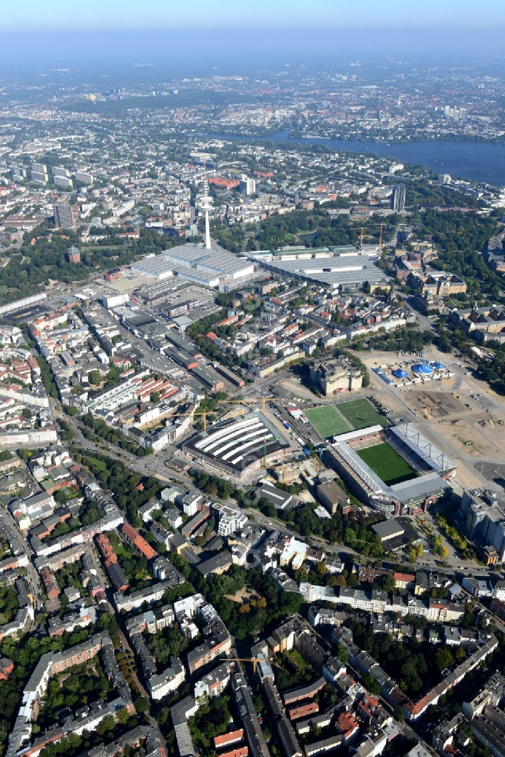 Hamburg from the bird's eye view: Exhibition grounds and exhibition halls of the Neue Messe at the broadcasting tower Heinrich-Hertz-Turm in Hamburg, Germany. Millerntor Stadium is located in front of it