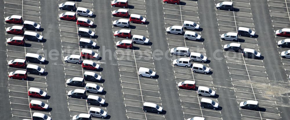 Etzin from the bird's eye view: Gelände der Auto- Service-und Umschlag- Center Mosolf GmbH in Etzin bei Nauen. Die Firma besteht seit über 50 Jahren und bietet außer Logistikdienstleistungen, Kraftfahrzeugvermietung und -verkauf, ebenso Technik-, Prüfungs- und Ausstattungsdienste an. Site of the auto service center and transshipment Mosolf GmbH Etzin at Nauen. The company was founded over 50 years and in addition to logistics services, vehicle rental and sale, as well engineering, testing and equipment services.