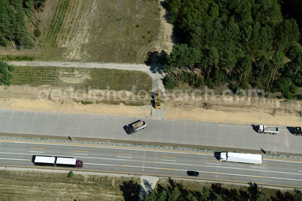 Friedrichshof from the bird's eye view: Routing and traffic lanes during the highway exit and access the motorway A 12 E30 in Friedrichshof in the state Brandenburg