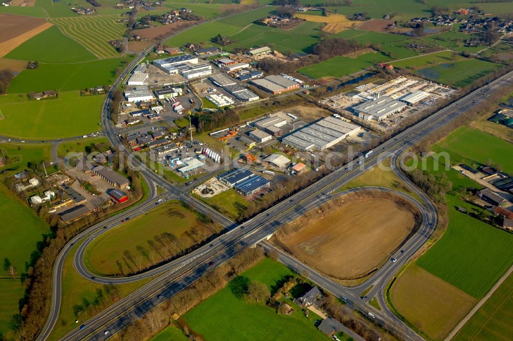 Aerial image Isselburg - Routing and traffic lanes during the highway exit and access the motorway A 3 and commercial area on B67 in Isselburg in the state of North Rhine-Westphalia