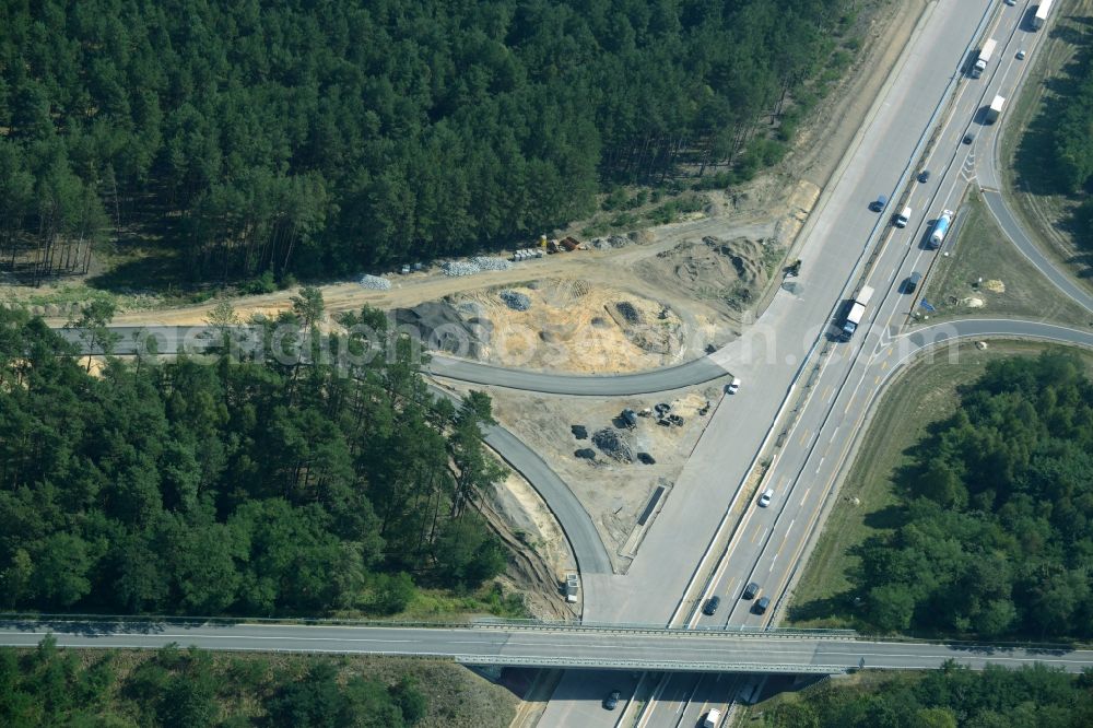 Friedrichshof from the bird's eye view: Routing and traffic lanes during the highway exit and access the motorway A 12 E30 in Friedrichshof in the state Brandenburg