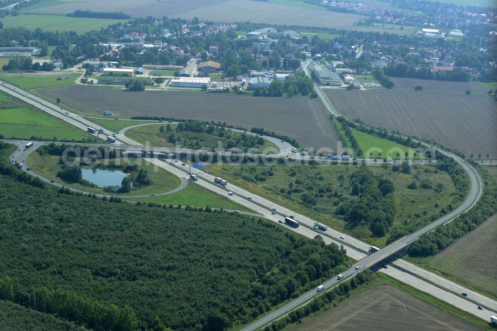 Aerial photograph Leipzig - Routing and traffic lanes during the highway exit Leipzig-Ost and access the motorway A 14 in Leipzig in the state of Saxony. A small pond is located in the interchange that connects the federal motorway with the B6 federal highway