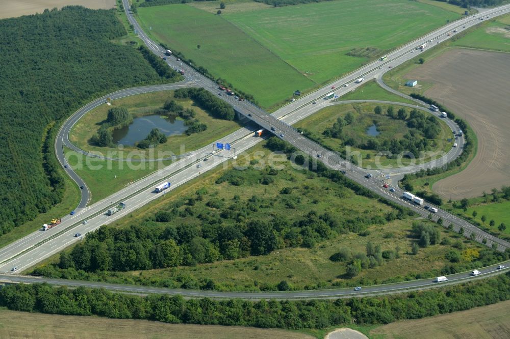 Leipzig from the bird's eye view: Routing and traffic lanes during the highway exit Leipzig-Ost and access the motorway A 14 in Leipzig in the state of Saxony. A small pond is located in the interchange that connects the federal motorway with the B6 federal highway