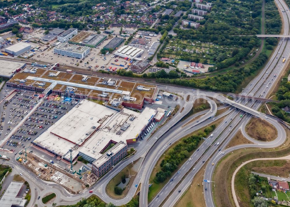 Kiel from the bird's eye view: Routing and lanes in the course of the exit and access to the motorway junction of the BAB A215 Citti -Park in Kiel in the state Schleswig-Holstein, Germany. Citti - Park - with parking lot and extension building site